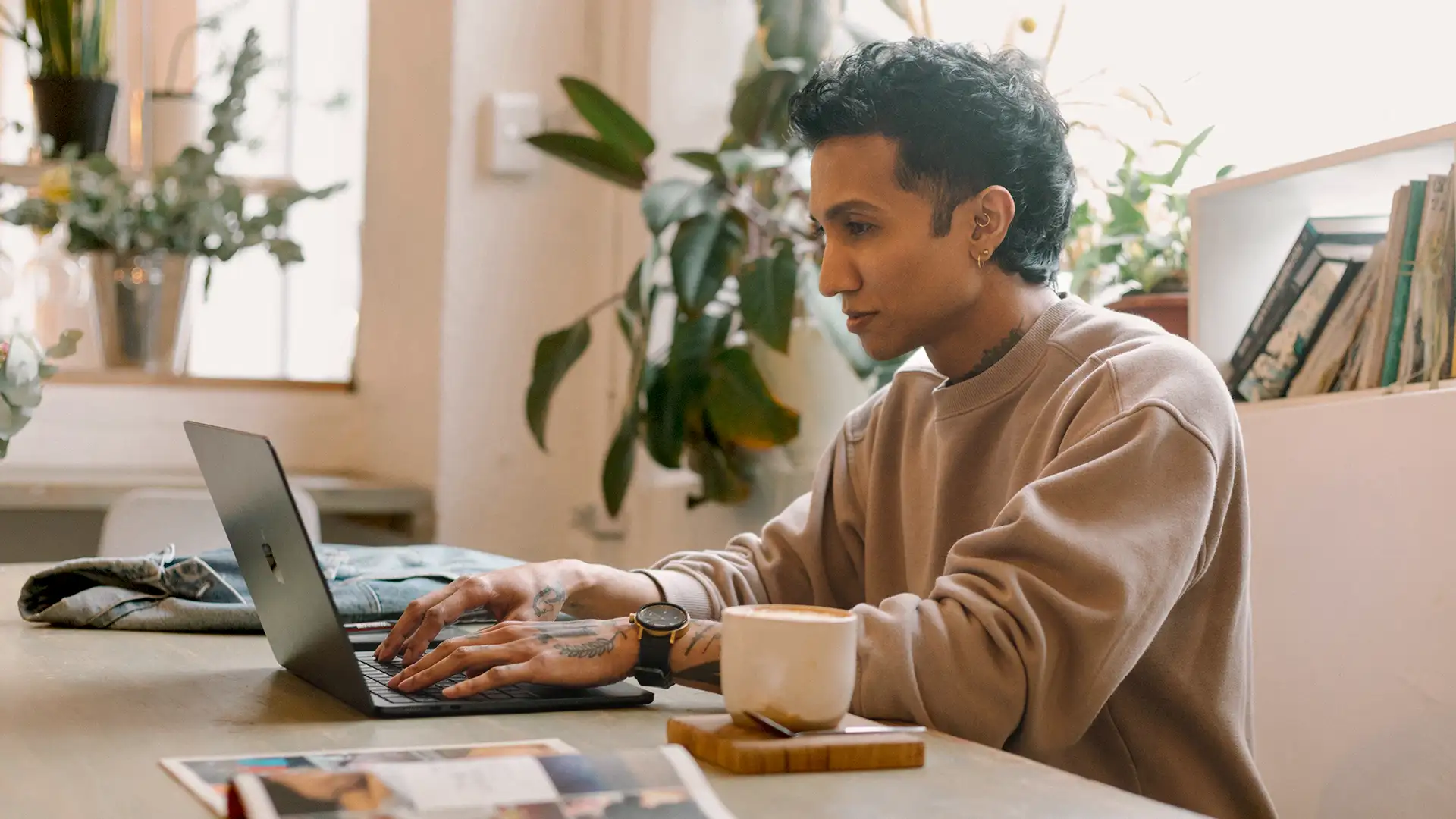 Side profile of Yajna Singh, Creative Director for bold brands, working on a laptop